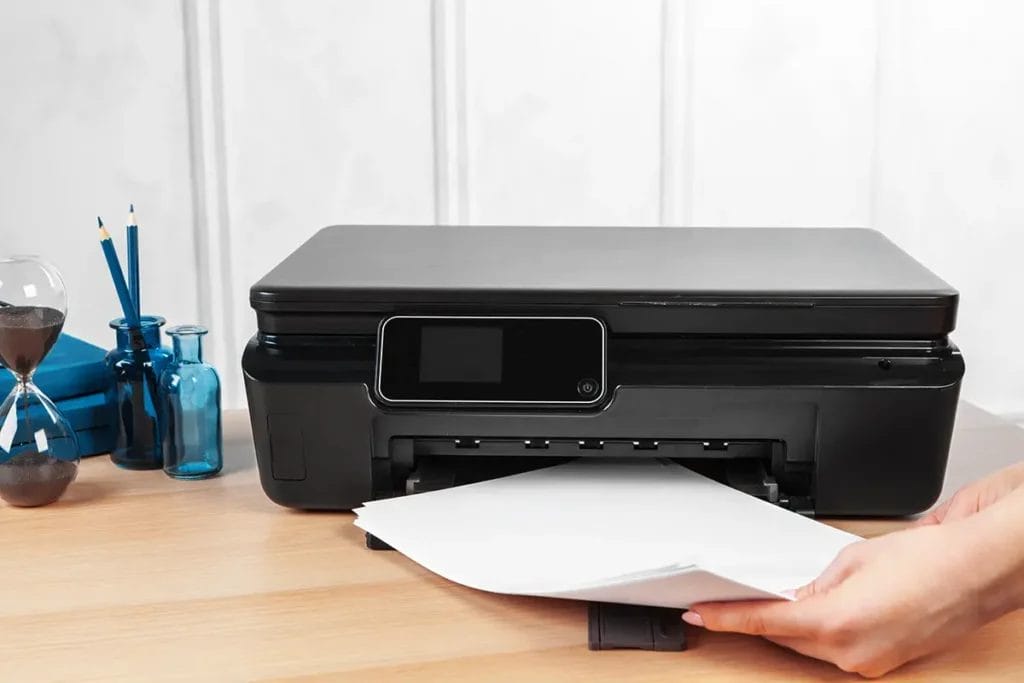 Female secretary making photocopies on xerox machine in office